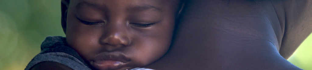 Image of a baby asleep on his mum's neck cc0