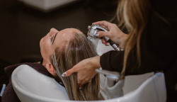 Image of a woman washing her hair. PD